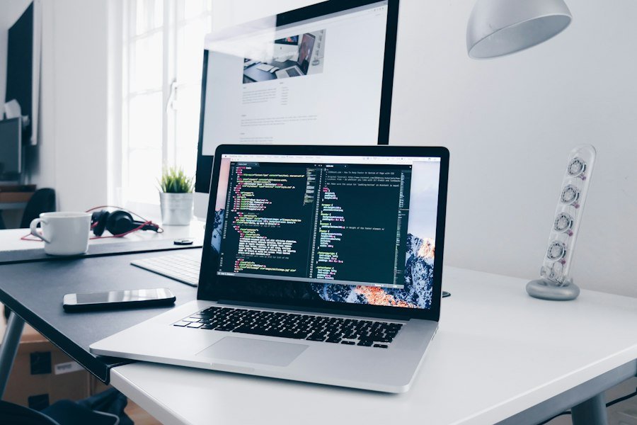 Laptop showing website code on a clean desk